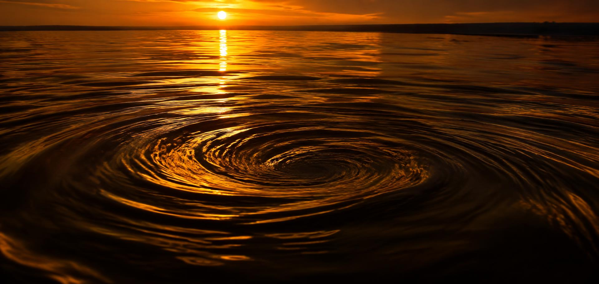 Golden water spiral at sunset