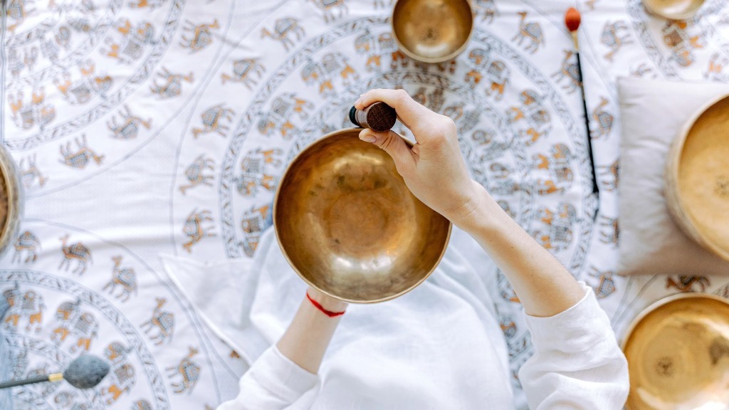Overhead view of an intentional sound session ceremony on a mandala cloth with singing bowls